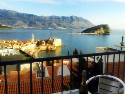 a view of a town on a body of water at Belvedere Apartments in Budva