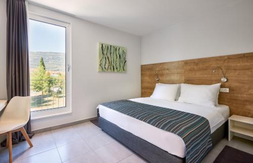 Un pat sau paturi într-o cameră la Hotel Štacija