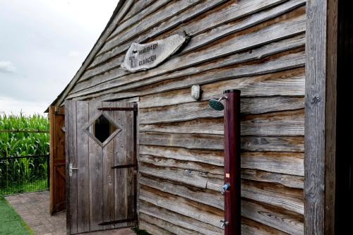 a wooden shed with a door on the side of it at Celebration Wellnesshuisje in Balkbrug