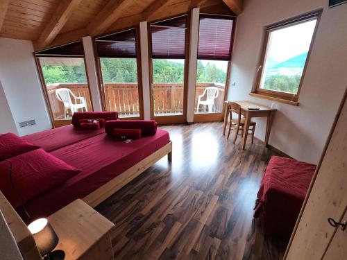 a living room with a bed and a large window at Agritur Fiore in Fondo