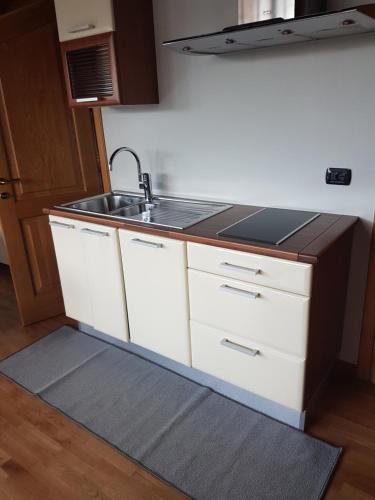 a kitchen with white cabinets and a sink at Casa Girardi in Peschiera del Garda