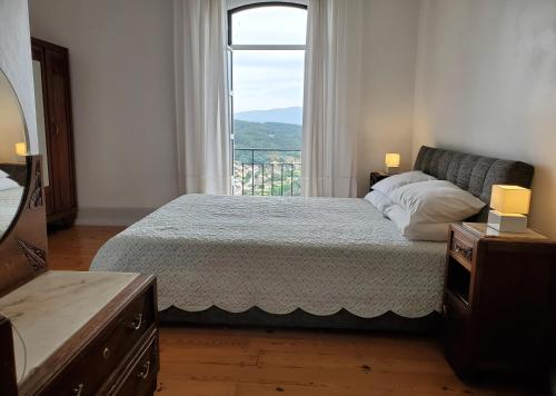 Un dormitorio con una cama grande y una ventana en Altíssima Guesthouse Penacova, en Penacova
