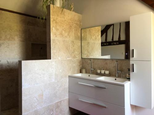 a bathroom with two sinks and a mirror at CAMPAGNE ET MER in Saâne-Saint-Just