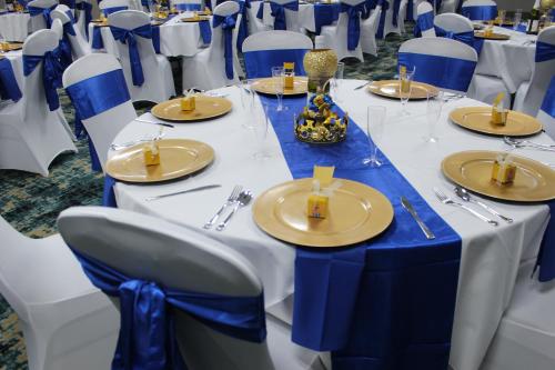 a table set for a wedding with blue and white tables and chairs at Holiday Inn Express Shawnee by IHG in Shawnee