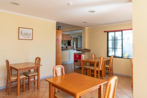 a dining room and kitchen with tables and chairs at TarmarPlace in Jardim do Mar