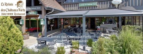 a restaurant with tables and chairs in front of a building at Le Relais Des Chateaux Forts in Bitche