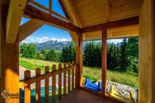 a view from the porch of a cabin with a view of the mountains at Osada Kościelisko - Tatry na Wyciągnięcie Ręki in Kościelisko