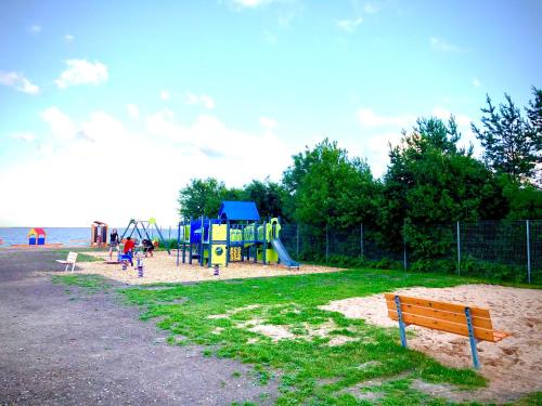 a park with a playground on the beach at Kibuvitsa Holiday House in Muratsi