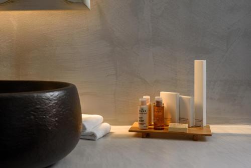 a bathroom with a shelf with products on a table at Soil of Sun Luxury Villas in Megalokhori