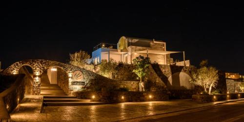 a house on a hill with a bridge at night at Soil of Sun Luxury Villas in Megalokhori