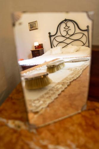 a mirror reflection of a bed with two pillows at L'OZioRinco Apartments in Florence