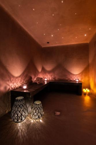 a room with a table and two stools with lights at Rochari Hotel in Mýkonos City