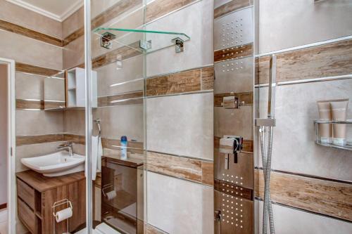 a bathroom with a shower and a sink at Upmarket Ultra Modern Sandton Apartment in Johannesburg