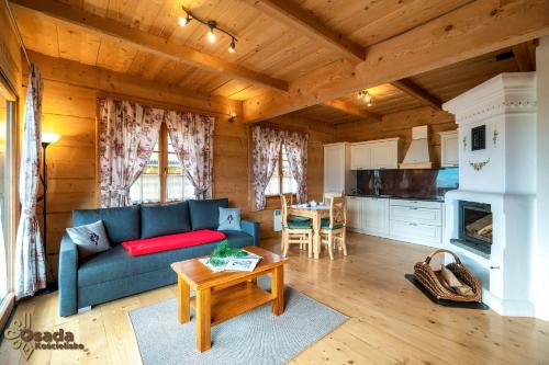 a living room with a couch and a table at Osada Kościelisko - Tatry na Wyciągnięcie Ręki in Kościelisko