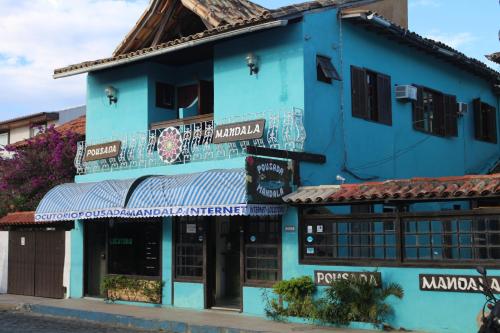 a blue building with a store in a street at Pousada Mandala - Búzios in Búzios