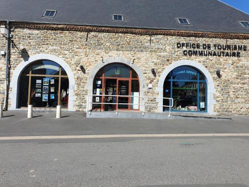 a brick building with two entrances to a store at GÏTE LE CONFLUENT in Vireux-Molhain