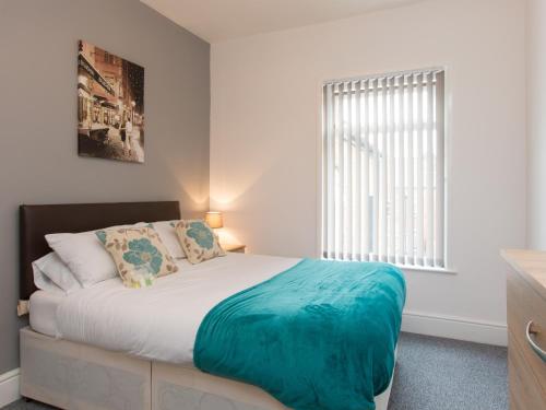 a bedroom with a bed and a large window at Townhouse @ Minshull New Road Crewe in Crewe