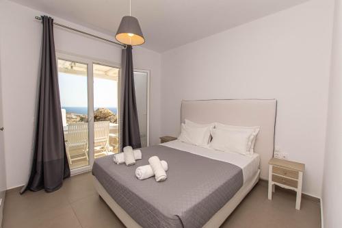 a bedroom with a bed with two towels on it at Lofos Apartments in Platis Gialos