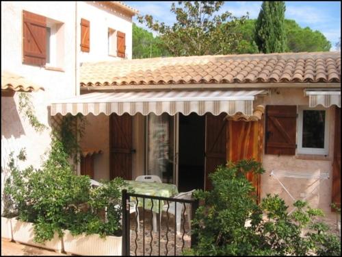 uma casa com um portão em frente em Location Villa et Studios Roquebrune-sur-Argens em Roquebrune-sur-Argens