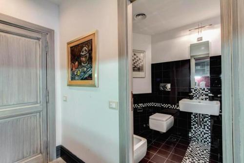 a bathroom with a sink and a toilet at 5 scole apartments in Rome