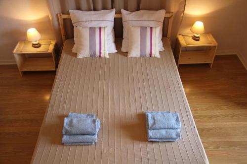 a bedroom with a bed with two towels on it at Au Lion d'Or in Le Puy en Velay