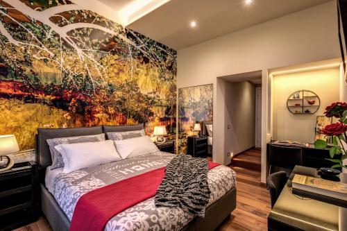 a bedroom with a large painting on the wall at Monticello apartment via Cavour in Rome