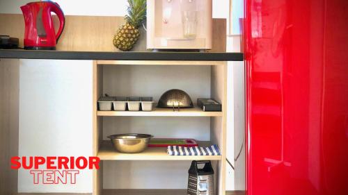 a toy kitchen with a shelf with food on it at Glamping Tents | Losinj | Camp Čikat in Mali Lošinj