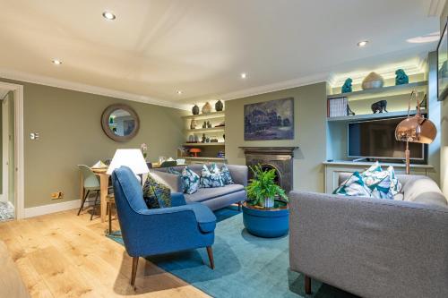 a living room with a couch and a fireplace at Beaches Brighton - Luxury Seafront Accommodation in Brighton & Hove