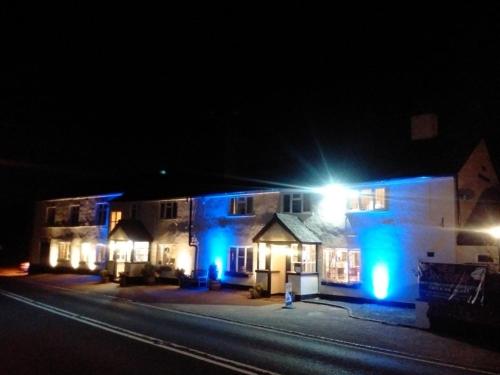 a building with blue lights on it at night at Blackbird House, Apartments and Studios in Wellington