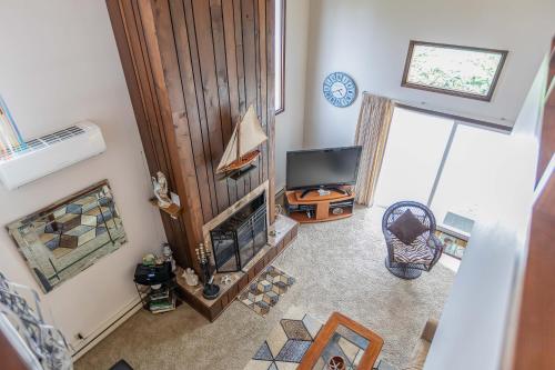 an overhead view of a living room with a television and a fireplace at Gaea House in Seaside