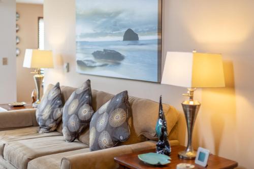 a living room with a couch with pillows at Gaea House in Seaside