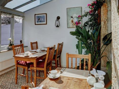 a dining room with a table and chairs at Bosavern House in St Just