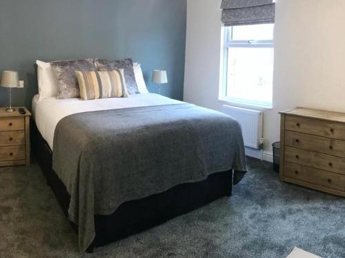 a bedroom with a bed and a window and a dresser at Botley Townhouse in Oxford