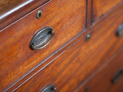 a wooden chest of drawers with a metal handle at Botley Townhouse in Oxford