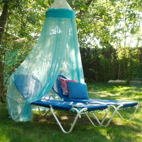 a hammock in a yard with a net at Can Portell by 123ole, B&B - Casa Rural in Sant Andreu del Terri