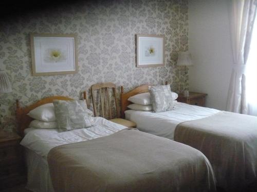 2 camas en una habitación de hotel con 2 camas dobles en The Broadfield, en Bridlington