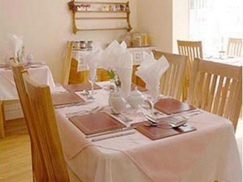 a table with a white table cloth on it at The Brockton in Bridlington