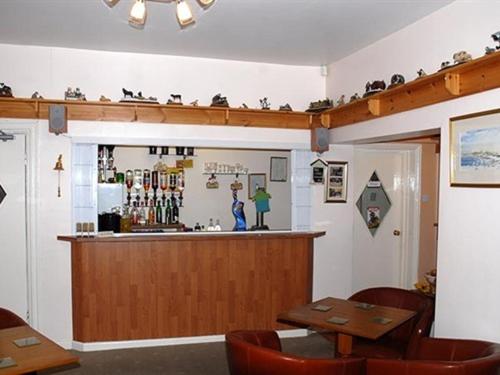 a bar in a restaurant with tables and chairs at The Brockton in Bridlington