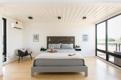 a bedroom with a bed and a large window at Geneseo Inn in Paso Robles