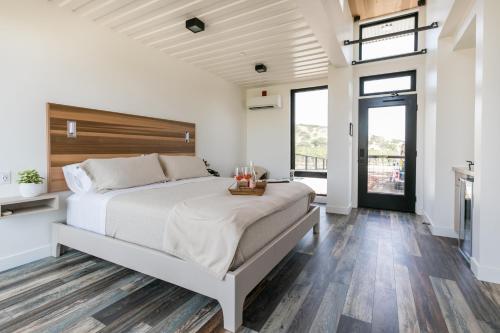 a bedroom with a large bed with a wooden headboard at Geneseo Inn in Paso Robles