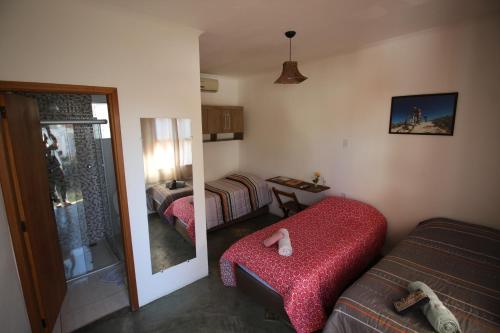 a living room with a couch and a mirror at Pousada Sempre Viva in São João Batista do Glória