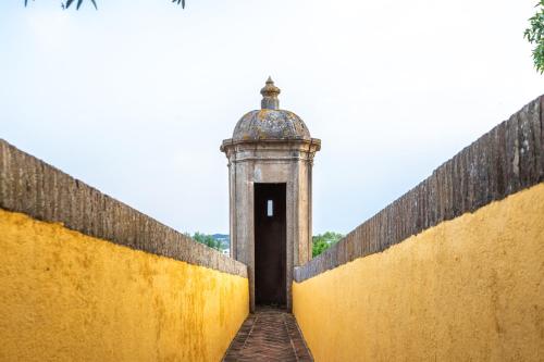 a small building with a door in a wall at Hotel Sao Joao De Deus by RIDAN Hotels in Elvas