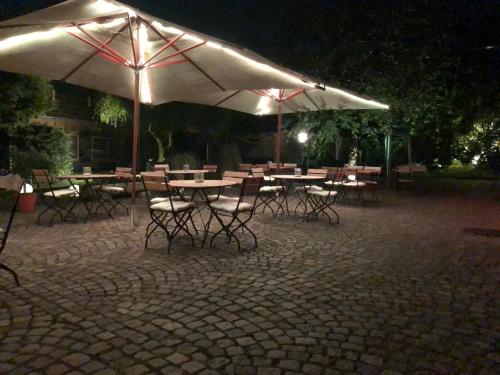 a group of tables and chairs with umbrellas at night at Kondrauer Hof in Waldsassen