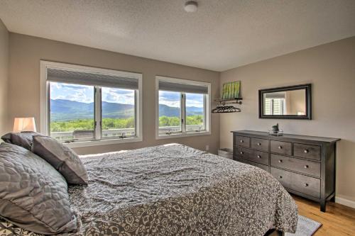 a bedroom with a bed and a dresser and windows at Family-Friendly Condo with Mtn Views, Community Pool in Intervale