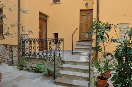 a set of stairs leading to a house with a door at La Corte in Arezzo