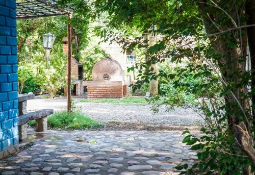 a stone walkway with a bench and a building at Azul Humahuaca Hostal in Humahuaca