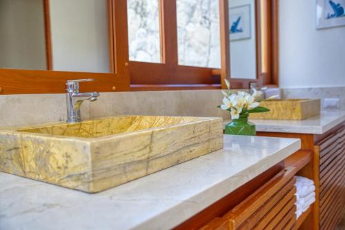 a bathroom with a wooden sink in a counter at ileverde 82 - Garden villa in Punta Cana