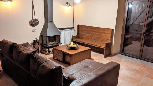 a living room with a couch and a fireplace at Pujolís in Santa Cecilia de Voltregá