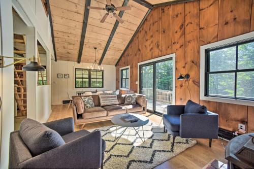 a living room with couches and a table at Sleek Cabin with Deck, 8 Miles to Mount Snow and Hikes in Wilmington