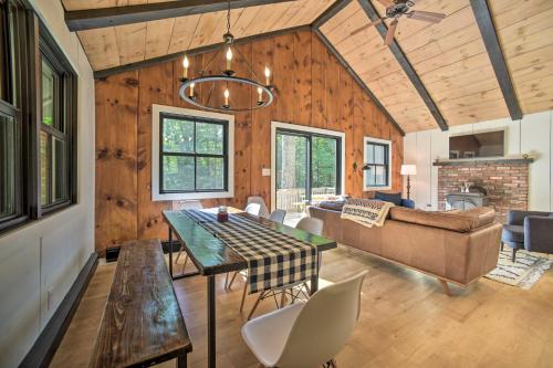a dining room and living room with a table and chairs at Sleek Cabin with Deck, 8 Miles to Mount Snow and Hikes in Wilmington